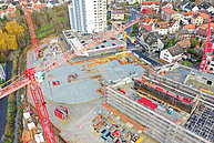 Luftbild Innenstadtbaustelle Übersicht mit Blick auf das Hochhaus am Inneren Ring. . Mehrere Baukräne sind zu sehen. Der Grundriss des neuen Rewe-Marktes ist erkennbar.